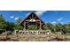 Elegant entrance sign for Mountain Crest Real Estate with stone accents and lush landscaping at 2470 Crimson Downs Dr, Cumming, GA 30040