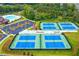 A great view of four well-maintained tennis courts and parking lot in a neighborhood at 2470 Crimson Downs Dr, Cumming, GA 30040