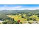 Picturesque rural view of property surrounded by lush green space, including nearby mountains at 3049 Highway 411 Ne, White, GA 30184