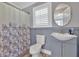 Well-lit bathroom features a shower curtain, sink, and wood floors at 3049 Highway 411 Ne, White, GA 30184