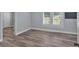 This bedroom features wood floors, neutral paint, window with blinds, and an entrance way at 3049 Highway 411 Ne, White, GA 30184