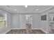 This bedroom features wood floors, neutral paint, window with blinds, and an entrance way at 3049 Highway 411 Ne, White, GA 30184