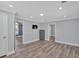 This bedroom features wood floors, neutral paint, a TV, and two entrances at 3049 Highway 411 Ne, White, GA 30184