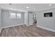 This bedroom features wood floors, neutral paint, a TV, and two entrances at 3049 Highway 411 Ne, White, GA 30184