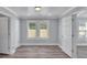 This bedroom has a window with blinds, and wood floors at 3049 Highway 411 Ne, White, GA 30184