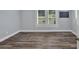 Well-lit bedroom with wood floors, window with blinds, and neutral paint at 3049 Highway 411 Ne, White, GA 30184