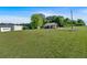 Lovely one-story home with wood siding, covered porch, brick foundation, gravel driveway, and large grassy yard at 3049 Highway 411 Ne, White, GA 30184