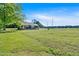 Lovely one-story home with wood siding, covered porch, brick foundation, gravel driveway, and large grassy yard at 3049 Highway 411 Ne, White, GA 30184