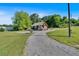 Lovely one-story home with wood siding, covered porch, brick foundation, gravel driveway, and grassy yard at 3049 Highway 411 Ne, White, GA 30184