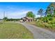 Lovely one-story home with wood siding, covered porch, brick foundation, gravel driveway, and grassy yard at 3049 Highway 411 Ne, White, GA 30184
