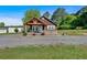 Charming one-story home with wood siding, covered porch, brick foundation, and gravel driveway at 3049 Highway 411 Ne, White, GA 30184