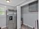 Well-lit kitchen featuring stainless steel refrigerator, window with blinds, and view into the utility area at 3049 Highway 411 Ne, White, GA 30184