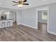 Spacious living room open to kitchen with bar seating, wood floors and neutral paint at 3049 Highway 411 Ne, White, GA 30184