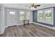 Inviting living room featuring wood-look floors, large windows, and neutral paint colors at 3049 Highway 411 Ne, White, GA 30184