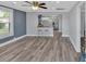 Living room featuring wood floors, modern light fixtures, neutral paint, and an open floor plan at 3049 Highway 411 Ne, White, GA 30184
