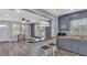 Open living room showcasing wood-look floors, bar seating, and natural light throughout at 3049 Highway 411 Ne, White, GA 30184