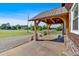 Covered porch with rustic wood beams, brick column supports, and concrete flooring at 3049 Highway 411 Ne, White, GA 30184
