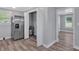 Utility area features modern stainless steel refrigerator, water heater and wood-look floors at 3049 Highway 411 Ne, White, GA 30184