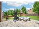Spacious backyard patio with a cozy seating area and a well-manicured lawn with a beautiful wooden perimeter fence at 4590 Hastings Dr, Cumming, GA 30041