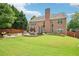 Spacious backyard featuring a stone patio, outdoor seating, and a lush lawn at 4590 Hastings Dr, Cumming, GA 30041
