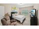 Cozy bedroom featuring neutral tones, a comfortable recliner, and a wall-mounted television at 4590 Hastings Dr, Cumming, GA 30041