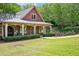 Inviting clubhouse with a covered porch and manicured lawn, offering a welcoming space for community gatherings and events at 4590 Hastings Dr, Cumming, GA 30041
