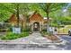 Charming clubhouse with stone accents, surrounded by mature trees and manicured landscaping, offering a welcoming community space at 4590 Hastings Dr, Cumming, GA 30041