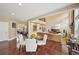 Open concept dining area leading to a living room with hardwood floors, large windows, and ample lighting at 4590 Hastings Dr, Cumming, GA 30041