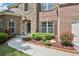 Close-up of the front entrance features brick accents, lush landscaping, and a welcoming walkway at 4590 Hastings Dr, Cumming, GA 30041