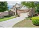 Well-maintained home featuring lush lawn, stone accents, and a two-car garage at 4590 Hastings Dr, Cumming, GA 30041