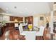 Eat-in kitchen with hardwood floors, granite countertops, stainless steel appliances, and a breakfast bar at 4590 Hastings Dr, Cumming, GA 30041