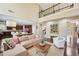 Spacious living room with hardwood floors, a high ceiling, and an open connection to the kitchen area at 4590 Hastings Dr, Cumming, GA 30041