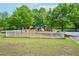 Fenced-in community playground with slides, climbing structures, and swings on a well-maintained grassy area at 4590 Hastings Dr, Cumming, GA 30041