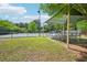 Community tennis courts surrounded by lush greenery with an awning covered seating area at 4590 Hastings Dr, Cumming, GA 30041