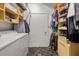 Large closet featuring custom shelving units with adjacent laundry area at 878 Peachtree Ne St # 431, Atlanta, GA 30309