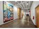 Bright hallway with polished concrete floors, artistic wall decor, and visible ceiling beams at 878 Peachtree Ne St # 431, Atlanta, GA 30309