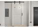 Hallway featuring a sliding barn door, pantry, and electrical panel at 878 Peachtree Ne St # 431, Atlanta, GA 30309