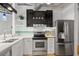 Modern kitchen with stainless steel appliances, white countertops, mosaic backsplash, and ample cabinet space at 878 Peachtree Ne St # 431, Atlanta, GA 30309
