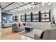 Charming living room featuring industrial ceilings, light wood floors, and views of the outside cityscape at 878 Peachtree Ne St # 431, Atlanta, GA 30309