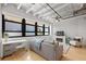 Bright living room featuring exposed ductwork, large windows, and a cozy fireplace at 878 Peachtree Ne St # 431, Atlanta, GA 30309