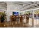 Lobby with long wood table, white stools, and TV in background at 878 Peachtree Ne St # 431, Atlanta, GA 30309