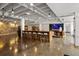 Lobby with long wood table and white stools with exposed ceiling at 878 Peachtree Ne St # 431, Atlanta, GA 30309