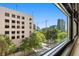A stunning window view showcases a neighborhood with mature trees and modern architecture at 878 Peachtree Ne St # 431, Atlanta, GA 30309
