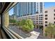 A stunning window view showcases a neighborhood with mature trees and modern architecture at 878 Peachtree Ne St # 431, Atlanta, GA 30309