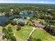The aerial view showcases a clubhouse, tennis courts, and a golf course with a lake in the community at 210 Wentworth Ter, Alpharetta, GA 30022