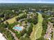 Aerial view of a community with a large pool, golf course, and homes, offering resort-style amenities at 210 Wentworth Ter, Alpharetta, GA 30022