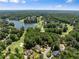 A scenic aerial view highlighting a lake, lush golf course, and beautiful homes in a vibrant community at 210 Wentworth Ter, Alpharetta, GA 30022
