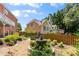 Landscaped backyard featuring a fountain, a spa, and a wood fence at 210 Wentworth Ter, Alpharetta, GA 30022