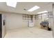 Unfinished basement with stainless steel appliances, shelving, and concrete flooring at 210 Wentworth Ter, Alpharetta, GA 30022