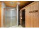 Bathroom with shower and sauna featuring a glass door and wood paneled walls at 210 Wentworth Ter, Alpharetta, GA 30022